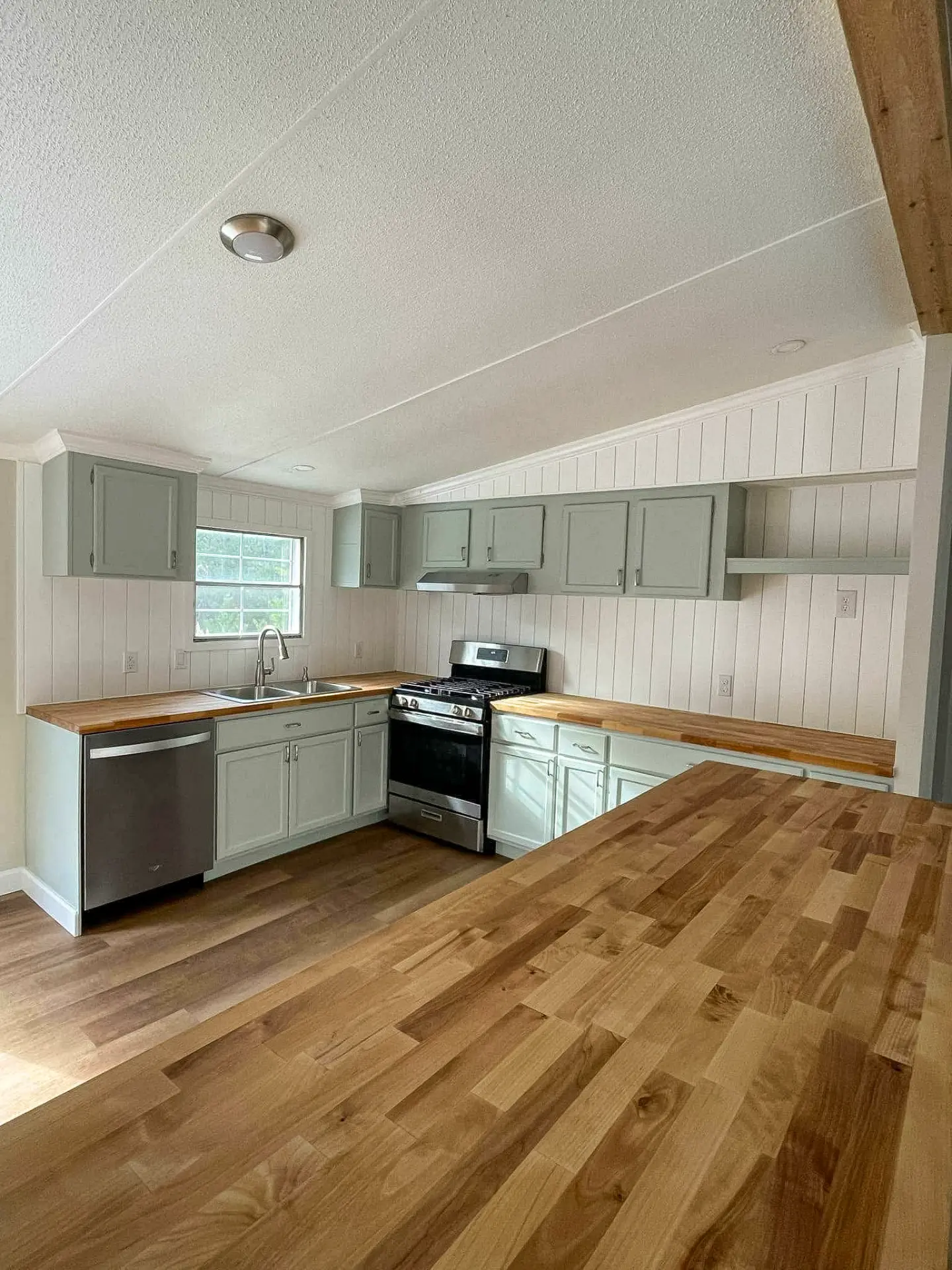 Custom luxury kitchen with wood beams and marble island